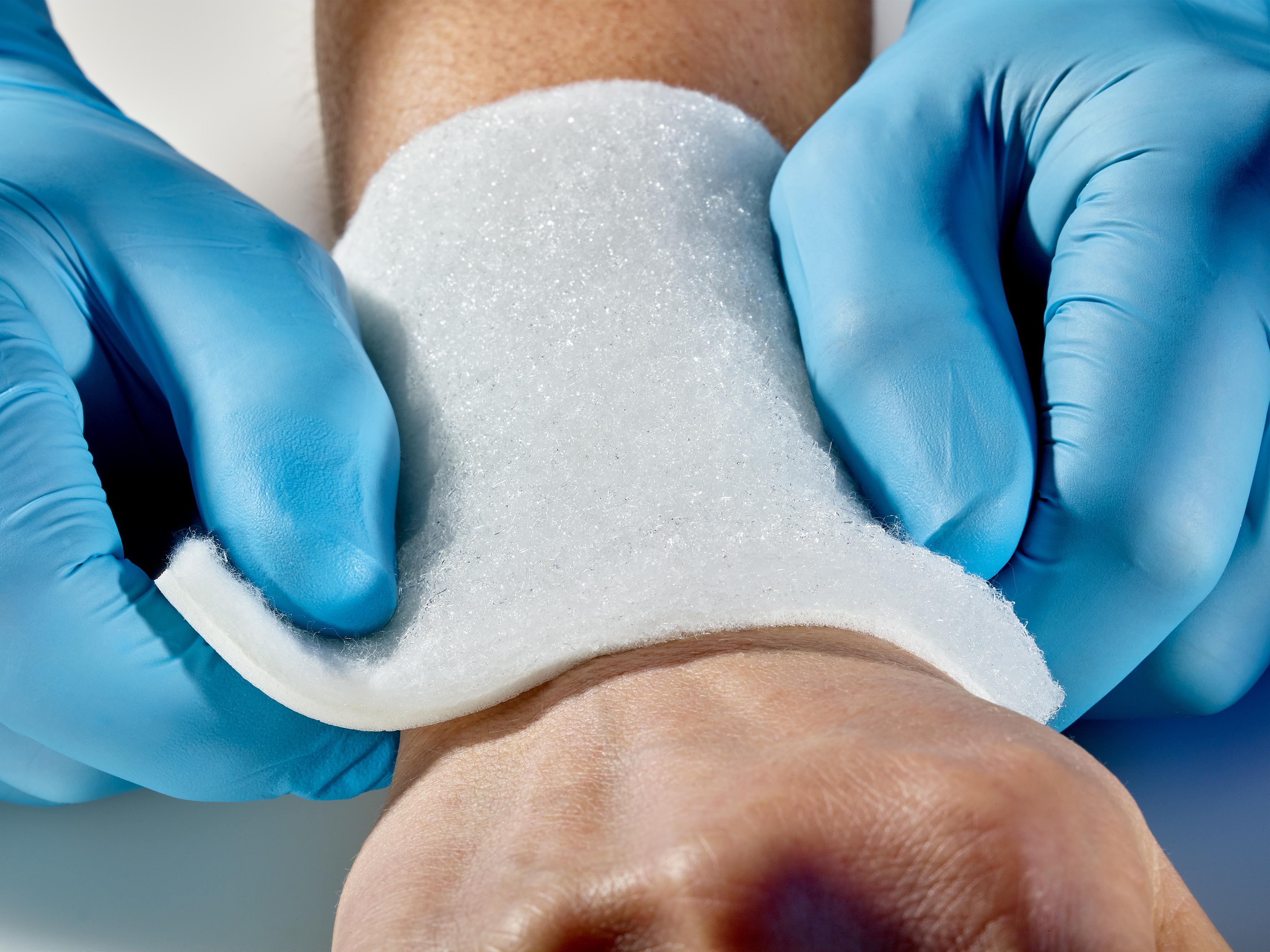 PU foam-nonwoven laminate